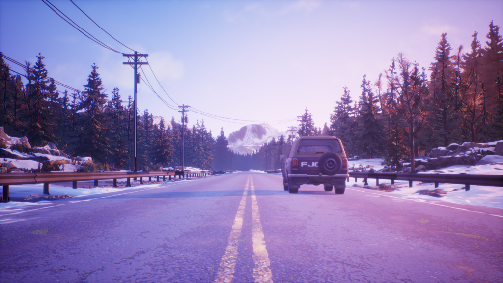 A car driving toward a mountain.